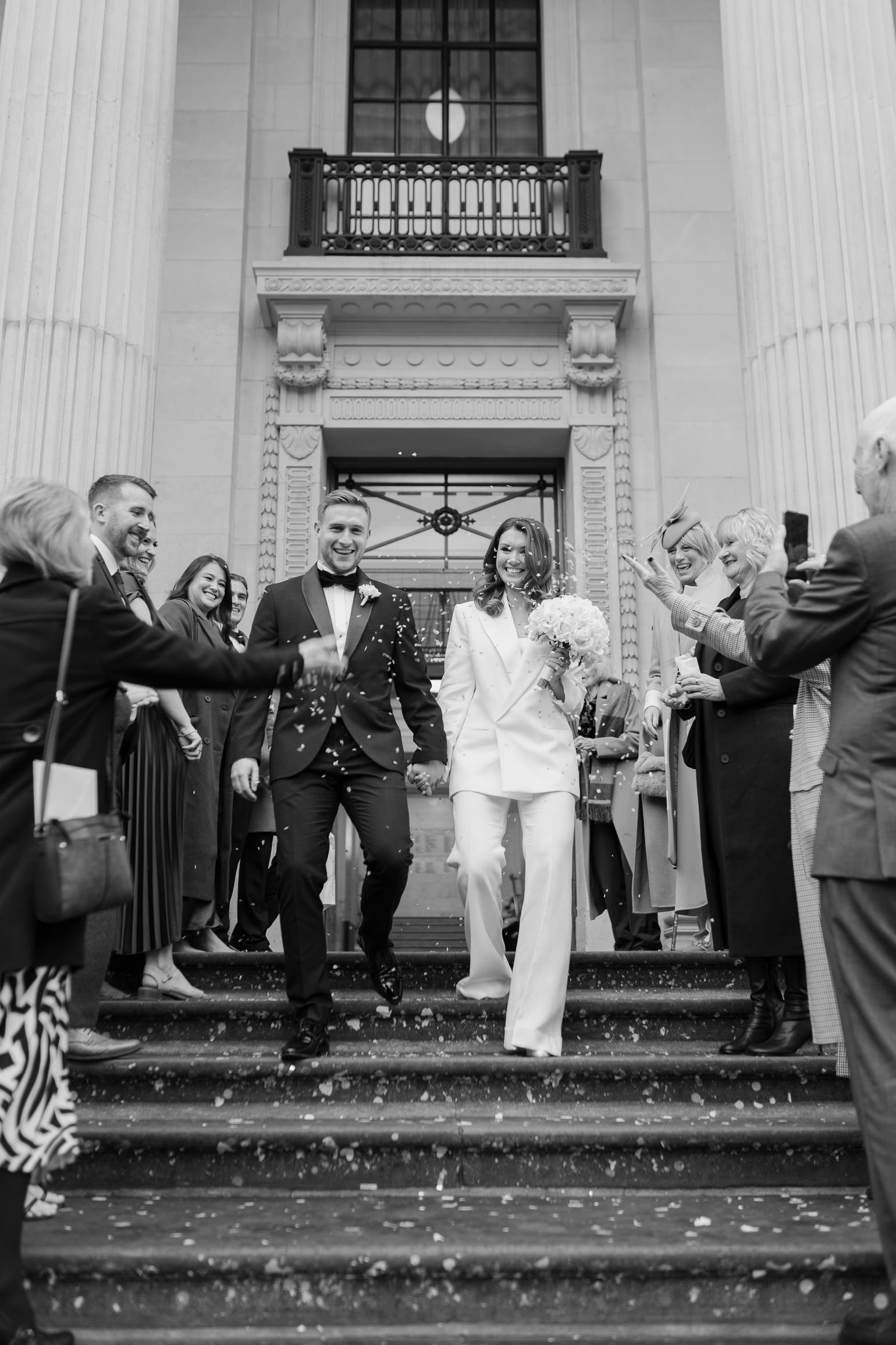 London wedding confetti with Victoria Beckham bridal suit. london wedding photographer, black-tie editorial London Wedding 