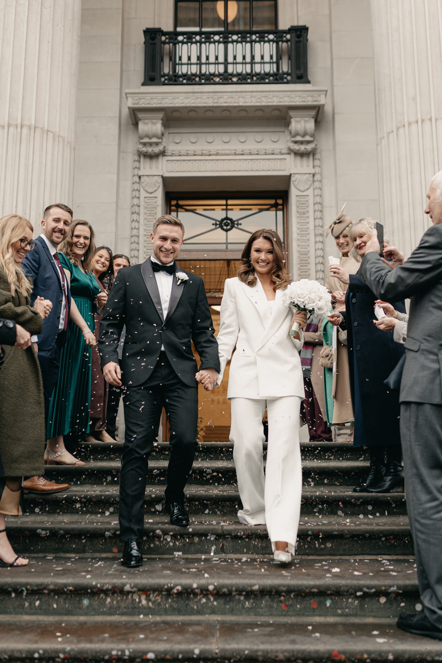 London wedding confetti with Victoria Beckham bridal suit. london wedding photographer, black-tie editorial London Wedding 